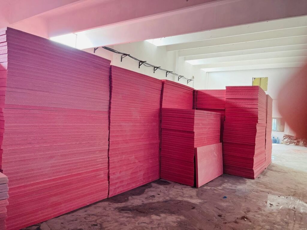 Pink XPS Jumbolon insulation boards stacked in warehouse