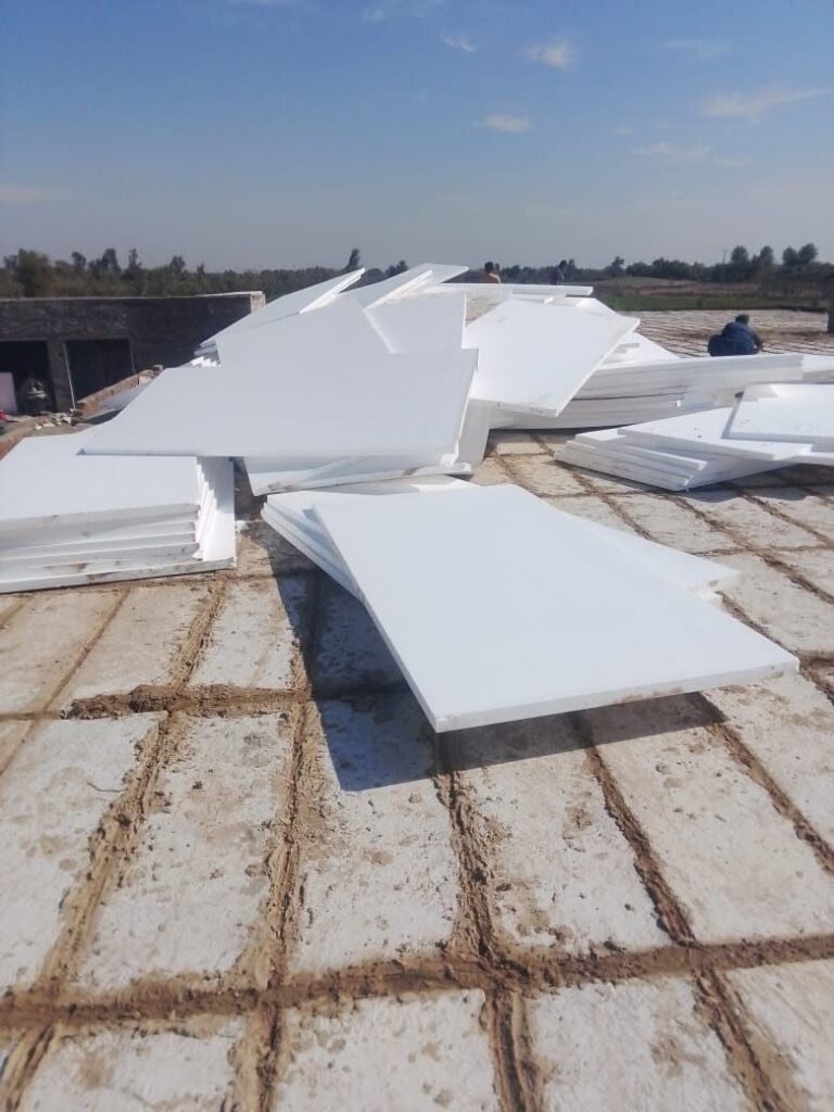 White EPS insulation sheets laid on a rooftop for thermal insulation