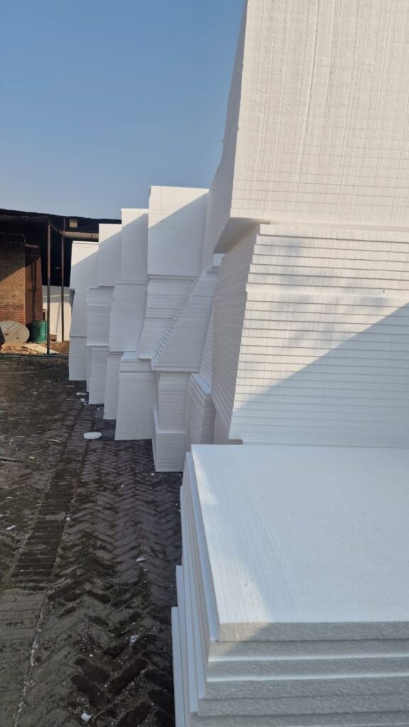 White EPS insulation sheets stacked vertically at storage yard