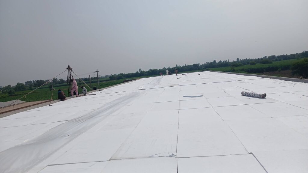 Flat roof covered with white waterproofing and insulation layer
