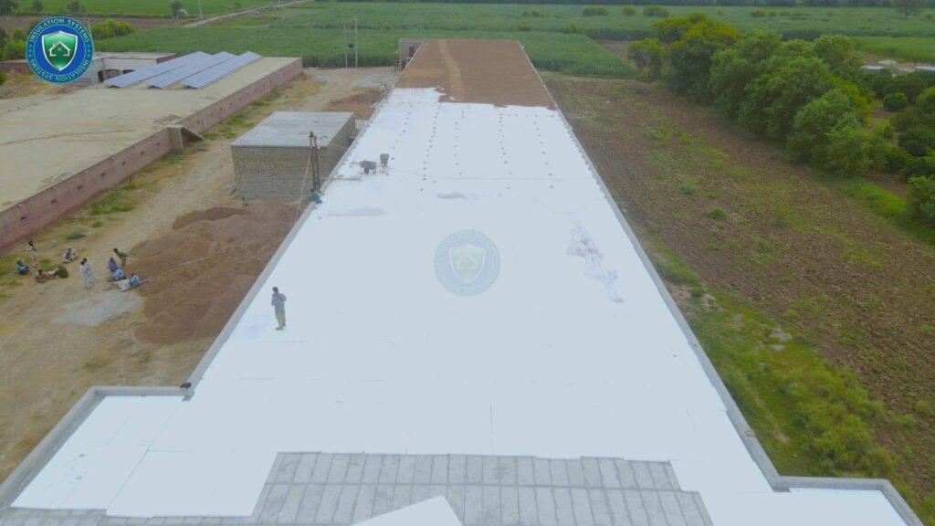 Long shed roof covered with white insulation layer by Insulation System team