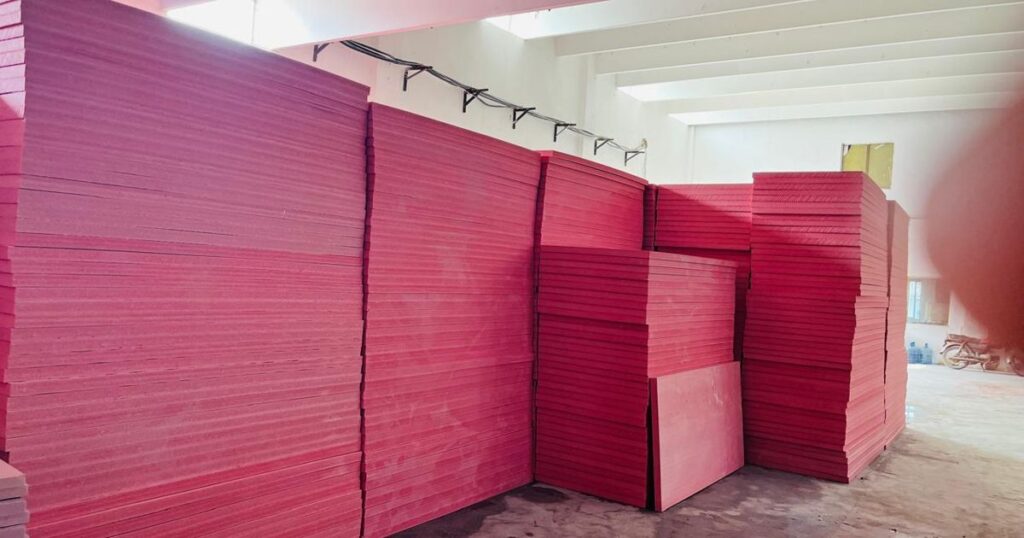 Pink Jumbolon XPS insulation boards stacked inside the Insulation System factory in Lahore