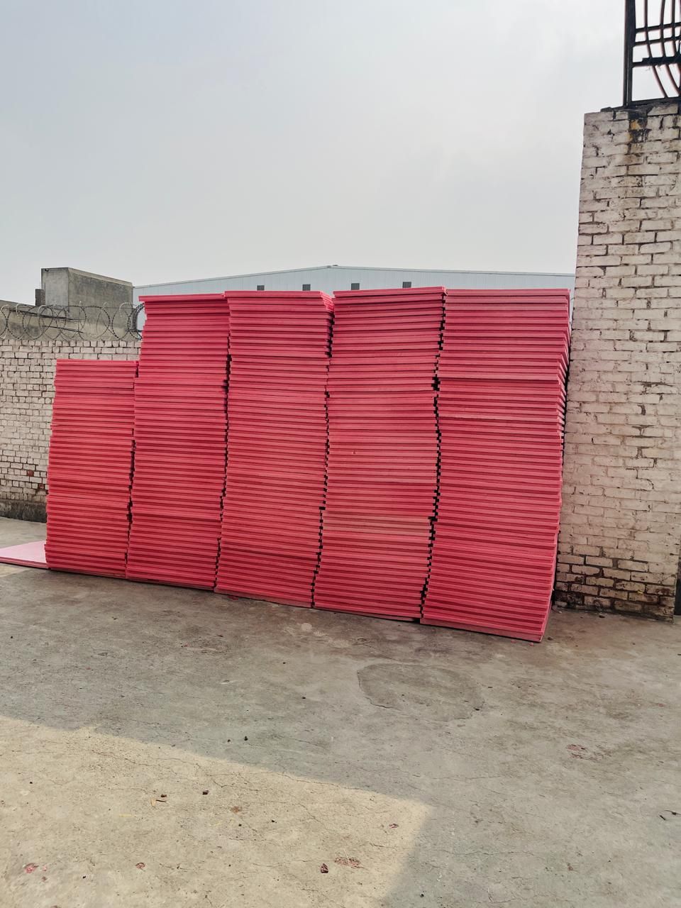 Pink Jumbolon XPS sheets stacked outdoors at the Insulation System factory in Lahore